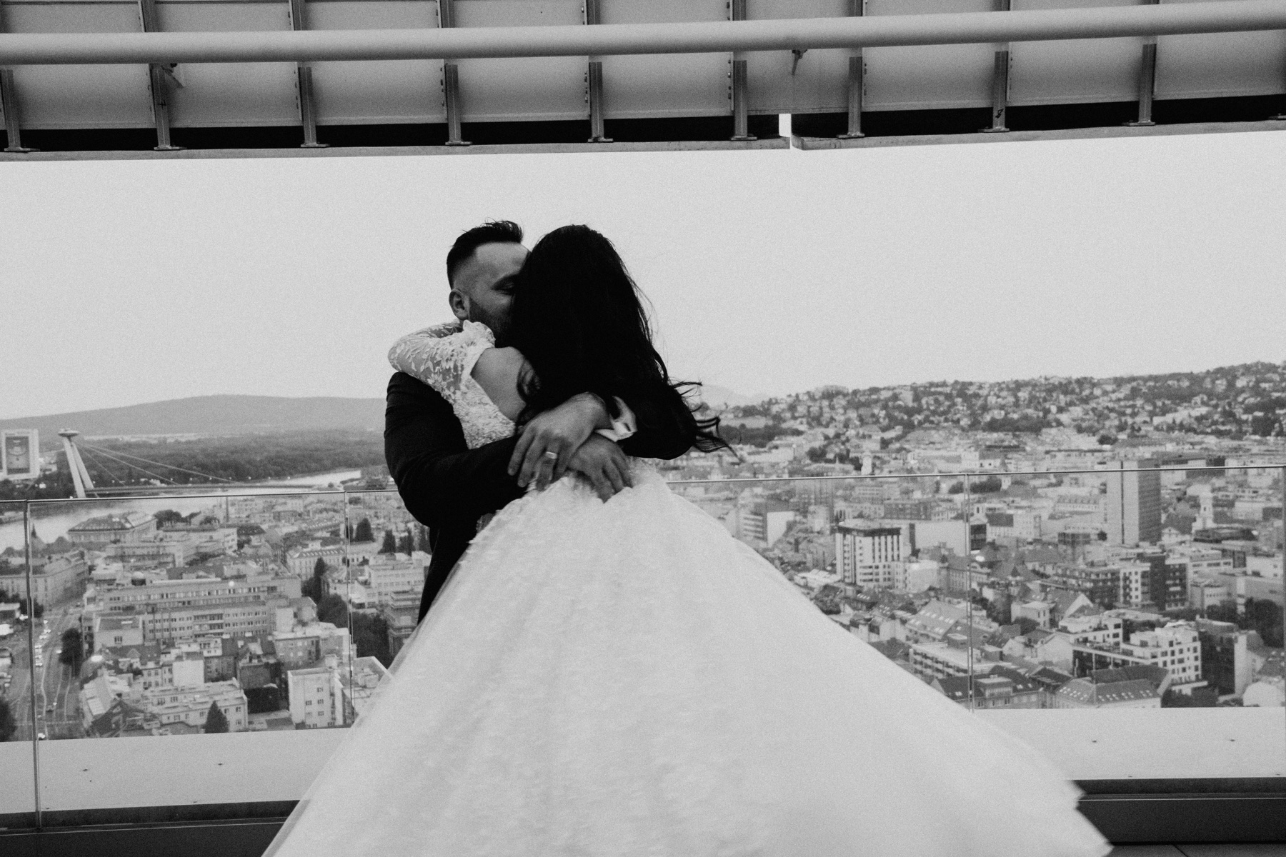 Wedding couple embracing above the city