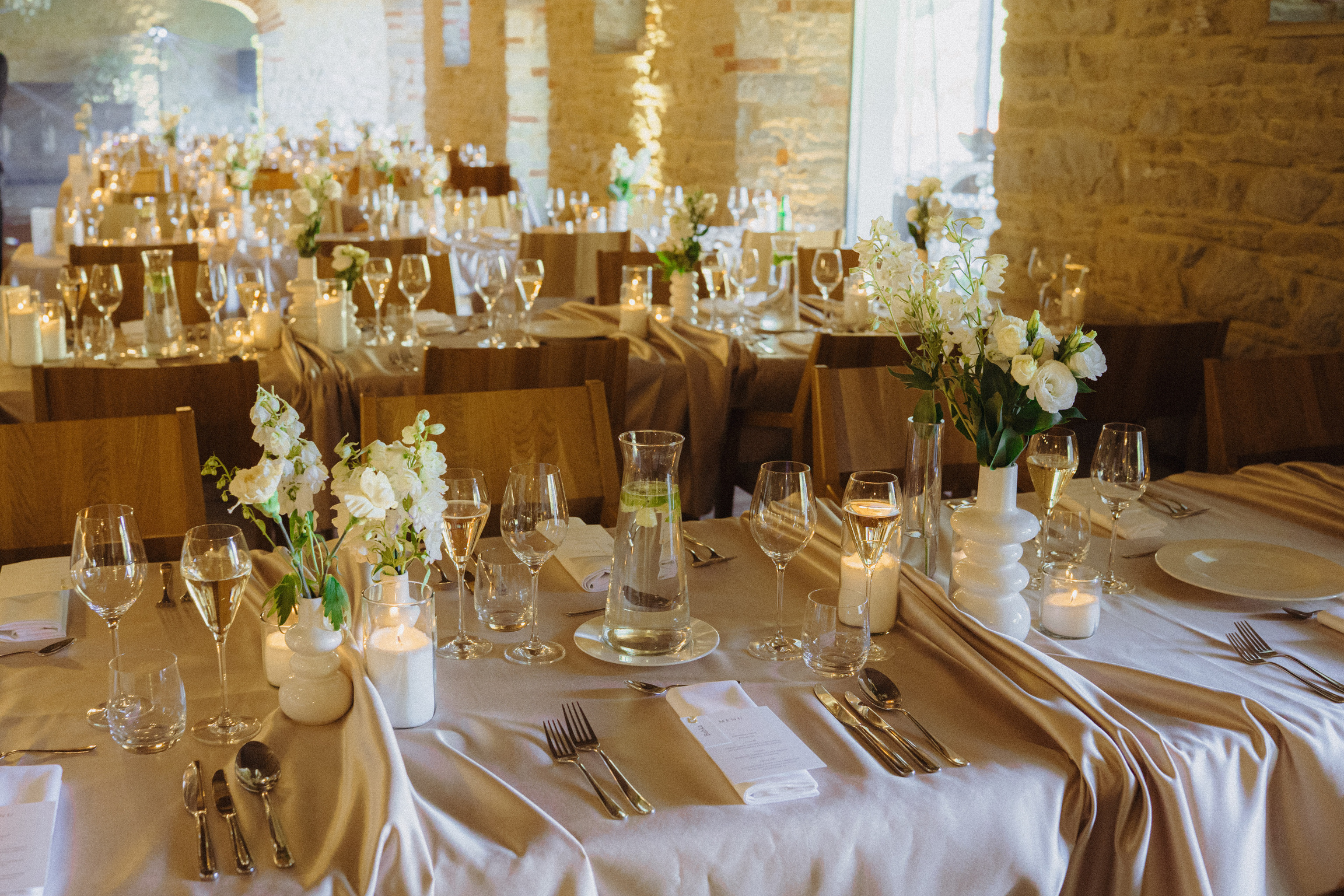 Wedding reception tables set with flowers and candles